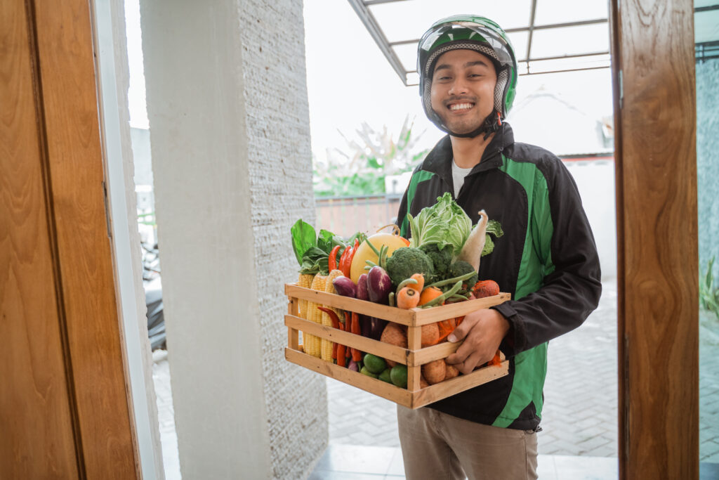 order online food courier delivering to customer at home. motorcycle delivery boy wear uniform and helmet